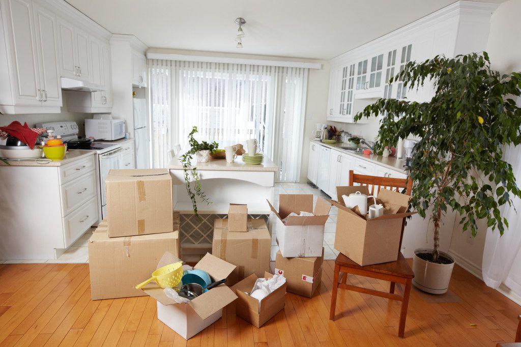 Kitchen packed with boxes during a move-out deep clean